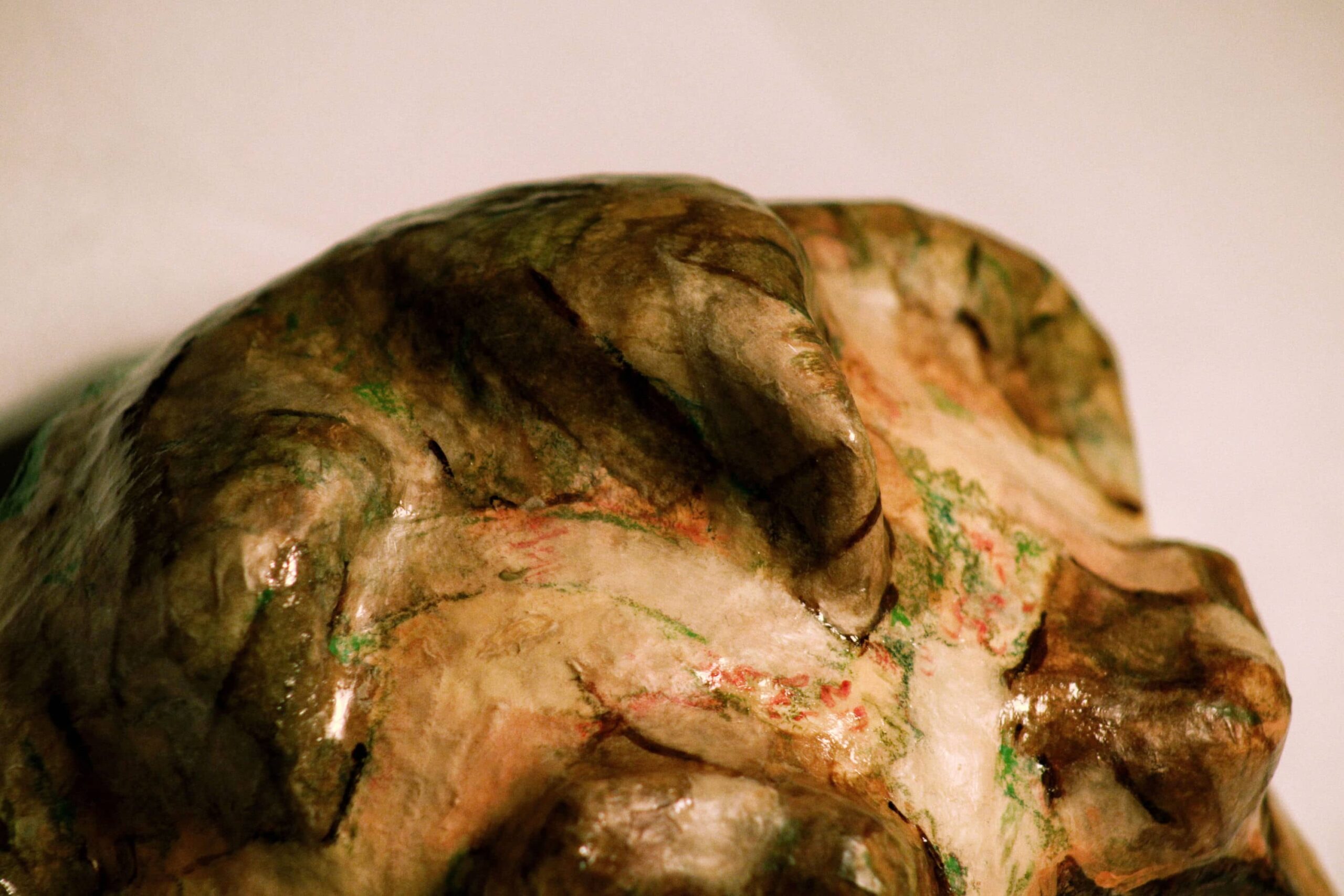 top detail of sculpted hair form, marked with expressive green and red strokes