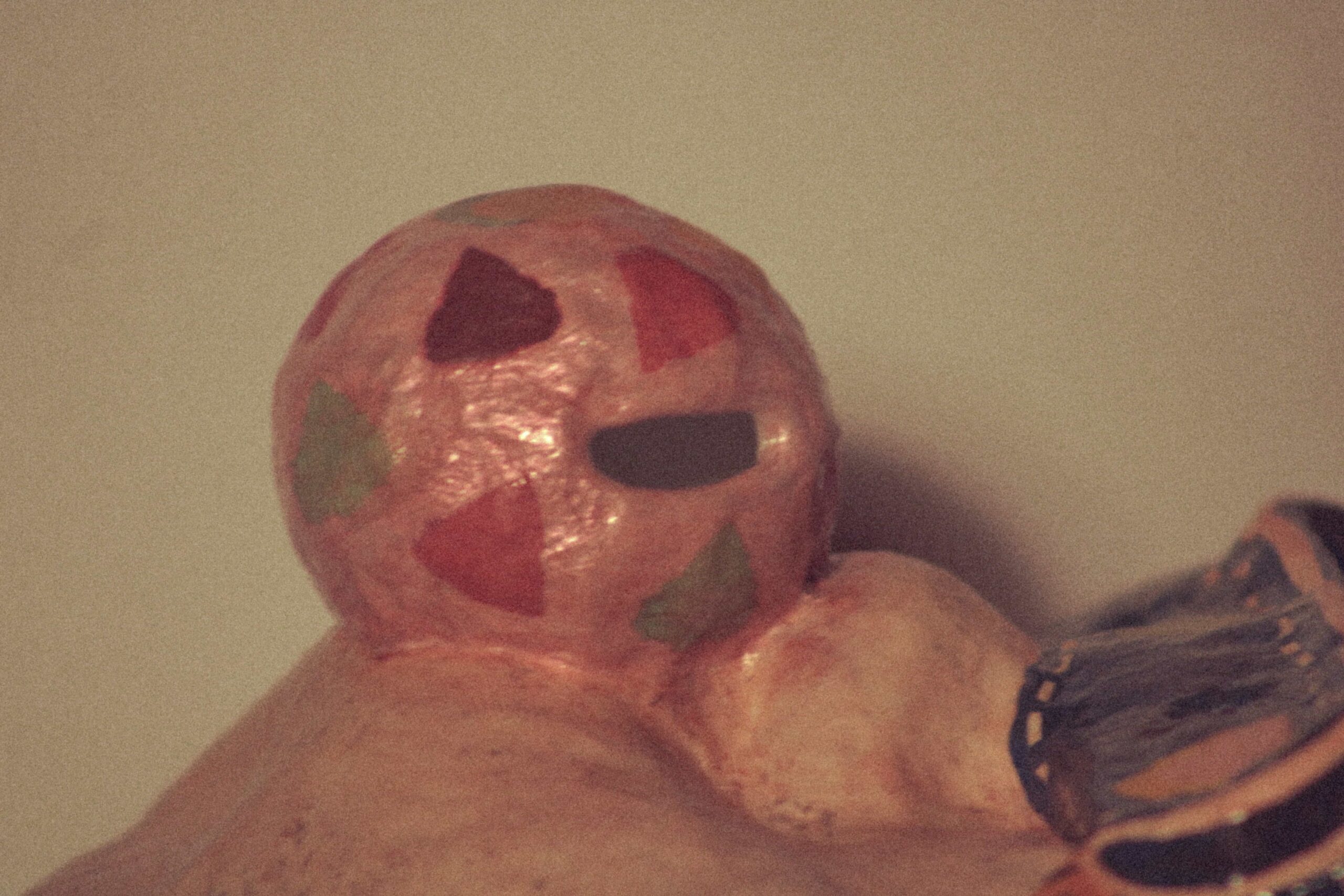 close-up of the mask's bubblegum balloon with multicolored painted pattern and textured finish